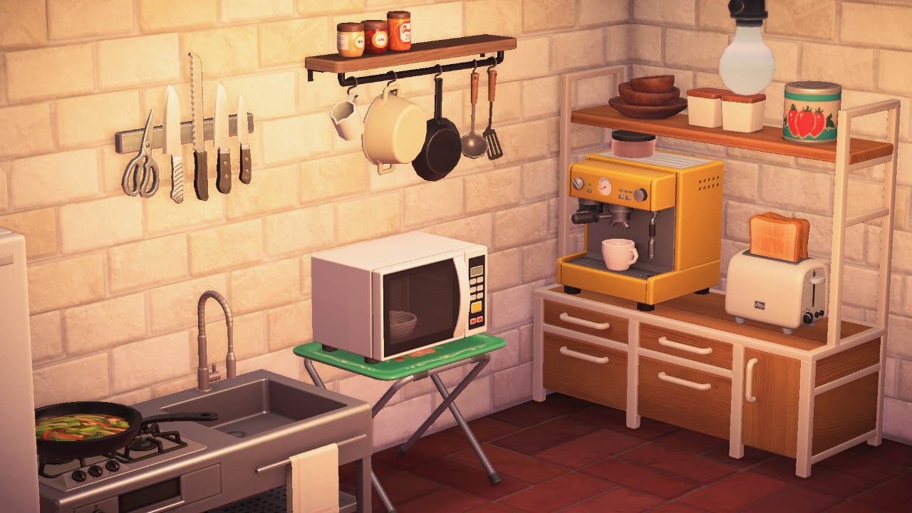 Cocina: microondas, cafetera, tostadora y cucharones en la pared