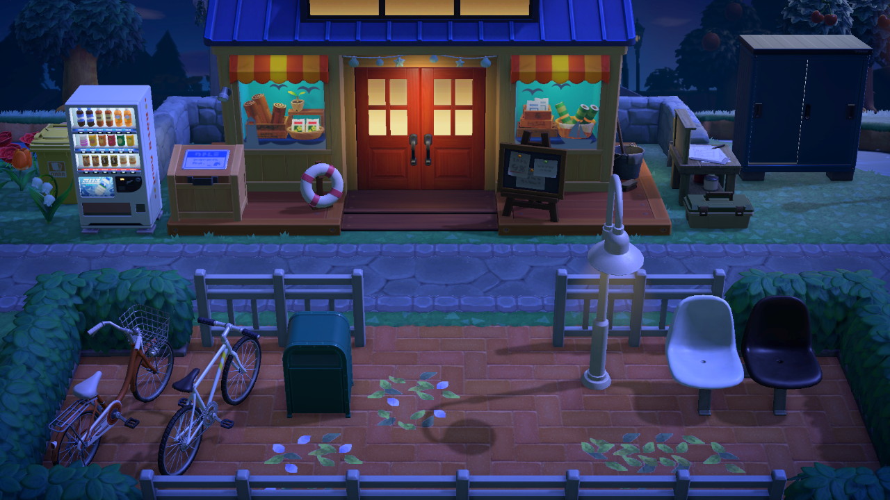 Banquitos y bicicletas frente a Nook's Cranny de noche